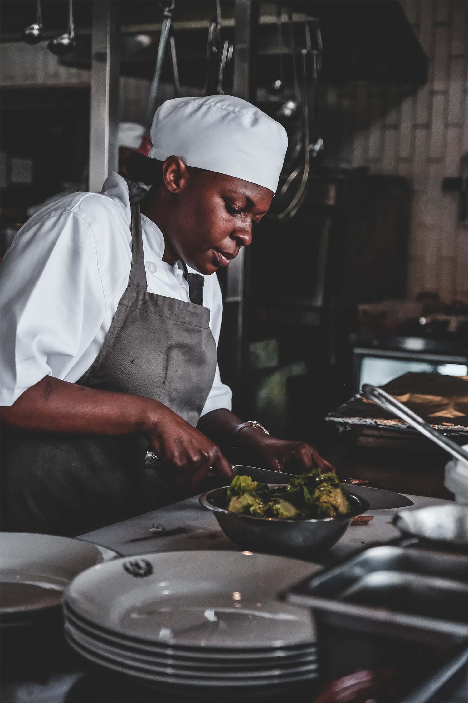 A chef cooking vegetables in the kitchen